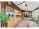 Bright and airy sun room featuring tile flooring, wood paneling, large windows and views of backyard greenery at 5402 Shadow Lawn Dr, Sarasota, FL 34242