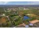 Stunning aerial view of a property with ponds and lush trees, highlighting its picturesque location near rural subdivisions at 5645 Churchill Downs Rd, Sarasota, FL 34241