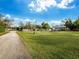 Expansive backyard with a long driveway and fenced enclosure at 5645 Churchill Downs Rd, Sarasota, FL 34241