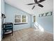 Empty bedroom with tile floors, natural lighting, and ceiling fan at 5645 Churchill Downs Rd, Sarasota, FL 34241