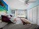 Bright bedroom with large closet, ceiling fan and light blue walls at 5645 Churchill Downs Rd, Sarasota, FL 34241