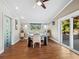 Dining room boasts stylish table and chairs, hardwood floors, and sliding glass doors at 5645 Churchill Downs Rd, Sarasota, FL 34241