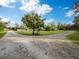 Long, gravel driveway leading to a property with a tree-lined entrance at 5645 Churchill Downs Rd, Sarasota, FL 34241