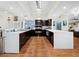Bright, expansive kitchen with white quartz countertops, dark cabinets, and stainless steel appliances at 5645 Churchill Downs Rd, Sarasota, FL 34241