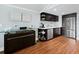 Well-appointed wet bar area with dark cabinets, modern appliances, and stylish mosaic backsplash at 5645 Churchill Downs Rd, Sarasota, FL 34241
