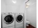 Well-lit laundry room featuring front loading washer and dryer and toilet at 5645 Churchill Downs Rd, Sarasota, FL 34241