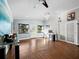 Spacious room with hard wood flooring, a stylish chandelier, and natural light from the windows at 5645 Churchill Downs Rd, Sarasota, FL 34241