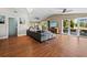 Bright living room features hardwood floors, sliding glass doors, and comfortable gray couch at 5645 Churchill Downs Rd, Sarasota, FL 34241