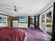 Inviting main bedroom with plush carpet, a ceiling fan, and access to the yard at 5645 Churchill Downs Rd, Sarasota, FL 34241