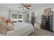 Bedroom featuring sliding glass doors with access to lanai, two dressers, and neutral walls at 625 Ennis Nw Ter, Port Charlotte, FL 33952