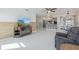 Spacious living room with neutral tones, wood-look accent wall, and views into the kitchen and dining area at 625 Ennis Nw Ter, Port Charlotte, FL 33952