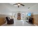 Cozy living room with recliner, shelving, wood-look accent wall, and natural light at 625 Ennis Nw Ter, Port Charlotte, FL 33952