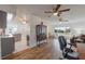 Open-concept living room showcasing hardwood floors and seamless flow into the adjacent kitchen at 625 Ennis Nw Ter, Port Charlotte, FL 33952