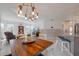 Open-concept living area with modern furniture, wood-look accent wall, and plenty of natural light at 625 Ennis Nw Ter, Port Charlotte, FL 33952