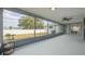Enclosed screened patio with view of large backyard and white fence offers an inviting outdoor living space at 625 Ennis Nw Ter, Port Charlotte, FL 33952