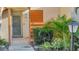 Inviting front entrance with a gray door, lush landscaping, and clear unit number at 144 Wild Palm Dr, Bradenton, FL 34210