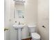 Bathroom with a pedestal sink and wood look flooring at 14923 Amberjack Ter, Lakewood Ranch, FL 34202