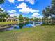 Scenic pond view with lush greenery and blue skies surrounding the houses at 14923 Amberjack Ter, Lakewood Ranch, FL 34202