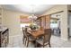 Elegant dining room with tile flooring, modern lighting, and sliding glass doors to the outdoor patio at 1577 Taggard Rd, North Port, FL 34288
