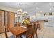 Bright dining area adjacent to the kitchen, featuring tile floors and modern pendant lighting at 1577 Taggard Rd, North Port, FL 34288