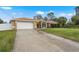 Charming single-story home showcasing a well-maintained lawn, a two car garage and neutral color palette at 1577 Taggard Rd, North Port, FL 34288
