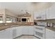 Bright kitchen featuring granite countertops, white cabinets, and modern appliances, offering a functional layout at 1577 Taggard Rd, North Port, FL 34288