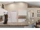 Kitchen boasts granite countertops and white cabinets, accented with an alligator sculpture at 1577 Taggard Rd, North Port, FL 34288