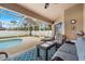 Inviting screened lanai with stylish outdoor furniture and views of the sparkling swimming pool at 1577 Taggard Rd, North Port, FL 34288