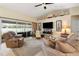 Comfortable living room with a fan and sofas, and a sliding glass door leading to the outdoor pool area at 1577 Taggard Rd, North Port, FL 34288