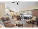 Spacious living room with vaulted ceilings, comfortable sofas, and access to an outdoor patio area at 1577 Taggard Rd, North Port, FL 34288
