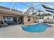 Inviting backyard oasis with a sparkling pool, screened enclosure, and comfortable patio furniture at 1577 Taggard Rd, North Port, FL 34288