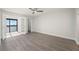 A bedroom featuring luxury vinyl plank flooring, french doors leading to the patio, and walk-in closet at 1751 Beach Rd # 404, Englewood, FL 34223