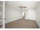 A bedroom with luxury vinyl plank flooring, a ceiling fan, and ensuite bathroom at 1751 Beach Rd # 404, Englewood, FL 34223