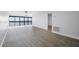 Bright living room featuring luxury vinyl plank flooring with access to the balcony at 1751 Beach Rd # 404, Englewood, FL 34223