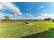 Spacious backyard featuring a fire pit, seating area, and lush landscaping at 22623 Morning Glory Cir, Bradenton, FL 34202