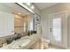 Well-lit bathroom featuring a granite vanity, large mirror, and a glass-enclosed shower at 22623 Morning Glory Cir, Bradenton, FL 34202