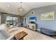 Spacious living room with high ceilings, a TV, and comfortable seating and view of screened pool at 22623 Morning Glory Cir, Bradenton, FL 34202