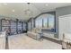 Cozy living room with a large window seat, custom bookshelves, and comfortable seating at 22623 Morning Glory Cir, Bradenton, FL 34202