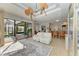 Spacious living area with bar seating, modern decor, and access to outdoor pool area at 22623 Morning Glory Cir, Bradenton, FL 34202