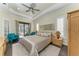 Comfortable bedroom with a king-sized bed, ceiling fan, and lanai access at 22623 Morning Glory Cir, Bradenton, FL 34202