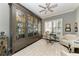 This home office features built-in shelving, shuttered windows, and comfortable seating at 22623 Morning Glory Cir, Bradenton, FL 34202