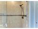 Close-up of a stylish shower with tile walls and a bronze shower head at 22623 Morning Glory Cir, Bradenton, FL 34202
