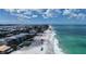 A stunning aerial view of beach homes lining a coast, with waves crashing along the beach at 2601 Gulf N Dr # B16, Bradenton Beach, FL 34217