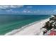 Expansive beachfront property showcasing turquoise waters and a pristine sandy shore under a partly cloudy sky at 2601 Gulf N Dr # B16, Bradenton Beach, FL 34217