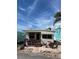 Charming exterior featuring a quaint patio, lovely decor, and a beautiful tropical palm tree at 2601 Gulf N Dr # B16, Bradenton Beach, FL 34217