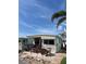 Charming exterior featuring a quaint patio, lovely decor, and a beautiful tropical palm tree at 2601 Gulf N Dr # B16, Bradenton Beach, FL 34217