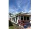 Exterior view showcasing a quaint patio and cozy outdoor seating area with a palm tree at 2601 Gulf N Dr # B16, Bradenton Beach, FL 34217