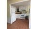 Efficient kitchen featuring white cabinets and appliances with tiled floor and adjacent dining area at 2601 Gulf N Dr # B16, Bradenton Beach, FL 34217