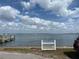 Scenic waterfront view of open water and blue skies, as well as a quaint pier at 2601 Gulf N Dr # B16, Bradenton Beach, FL 34217