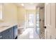 Bright bathroom with modern fixtures, a spacious shower, and access to the pool at 27425 Jones Loop Rd, Punta Gorda, FL 33982